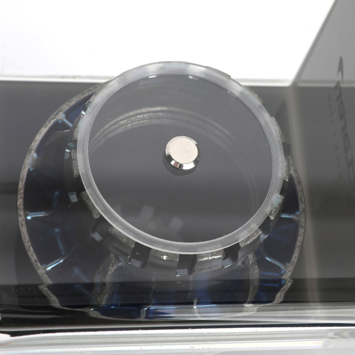 Authentic McLaren F1 Team 2025 blue wheel nut presented in a premium display case for collectors