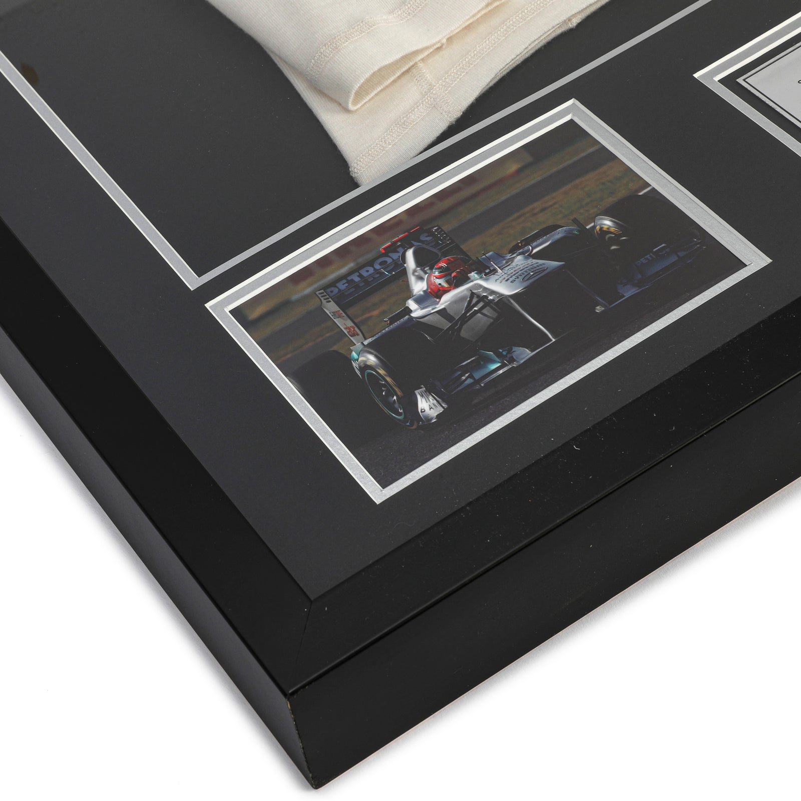 Season Launch LOT 027 - Michael Schumacher 2010 Mercedes Nomex - Framed