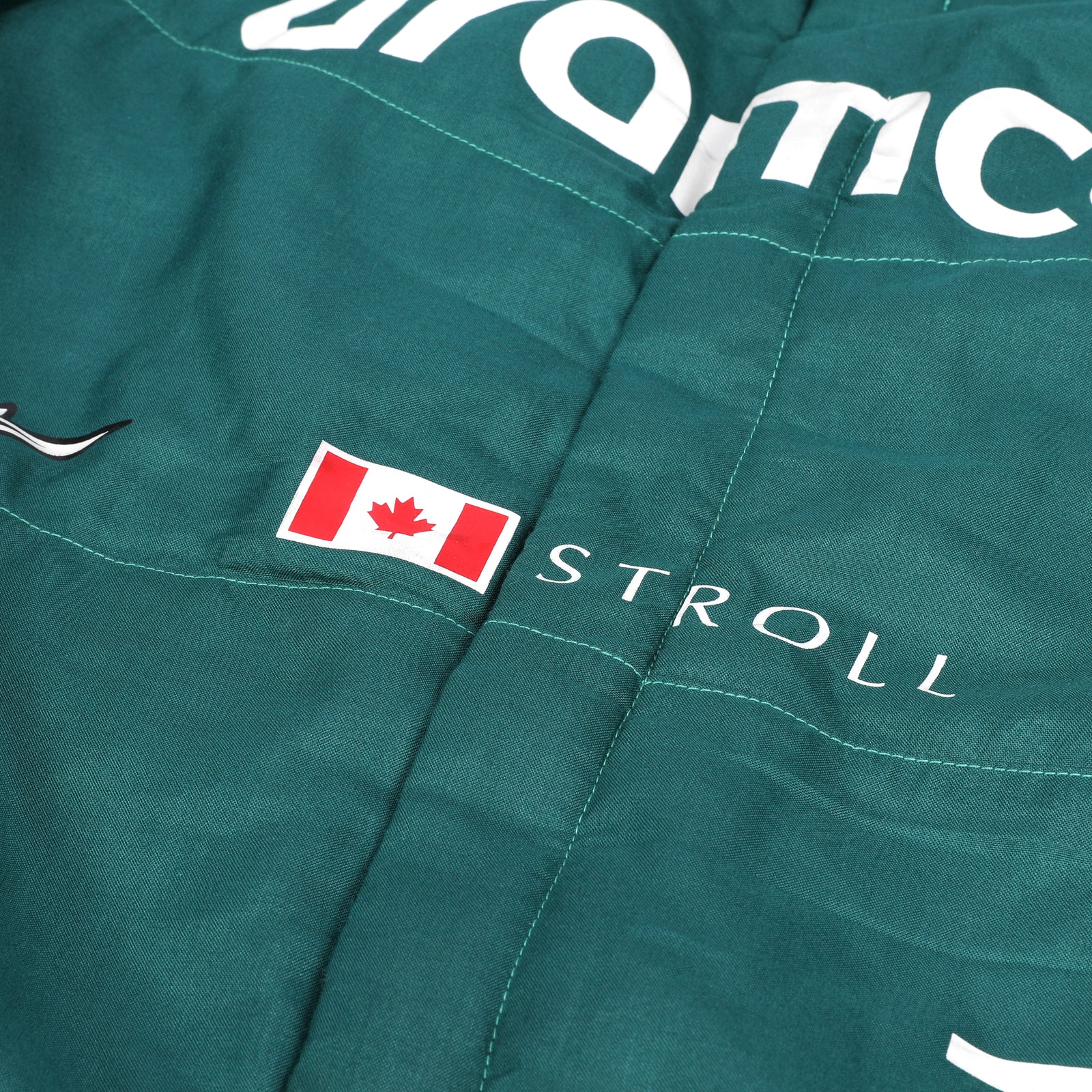 LOT 549 - Aston Martin Aramco Formula One® Team x Movember – Lance Stroll Suit & Wheel Rim