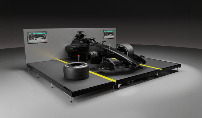Carbon fibre pit stop rig, front three-quarter view with a wheel off