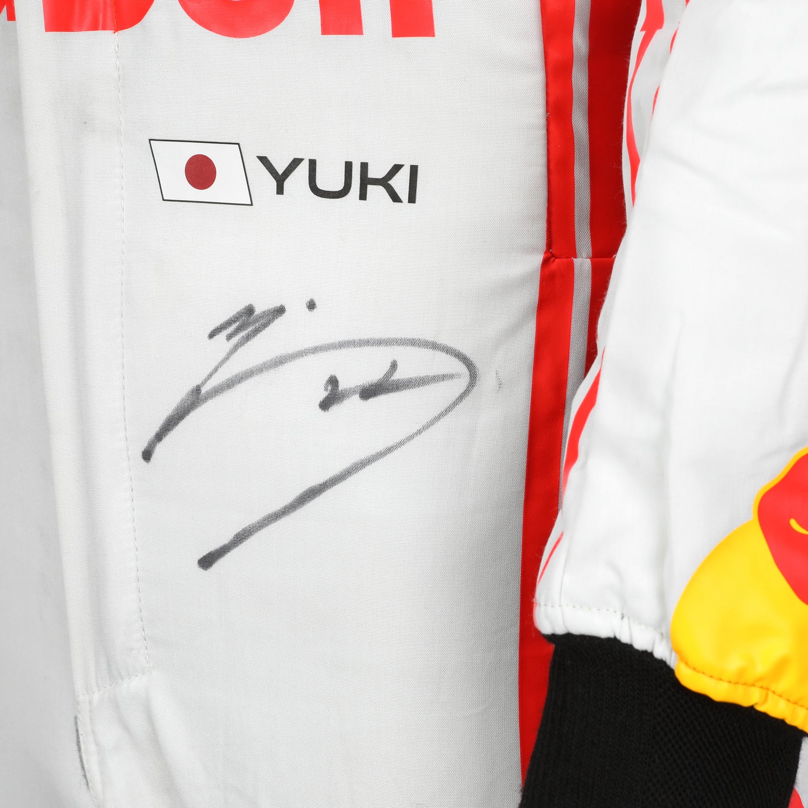 LOT 003 - Yuki Tsunoda 2025 Signed Race Weekend Used Race Suit - Japanese GP
